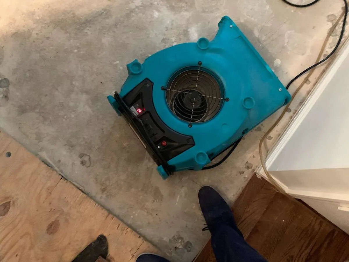 Air mover drying subfloor during Commercial Water Damage Restoration in Upper Deerfield